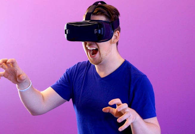 A gentlman interacting with VR goggles